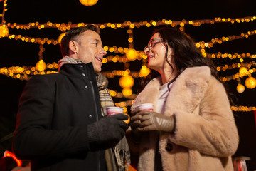 Wall Mural - Couple talking at Christmas market. Zagreb, Croatia.