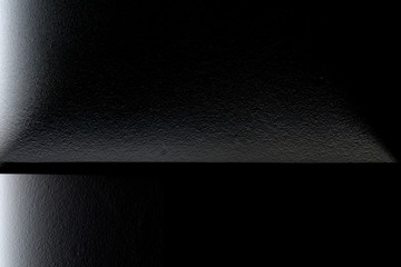 Poster - Chiaroscuro architecture photo with backlit windows glowing in darkness. Geometric abstract background with rectangular structure in black