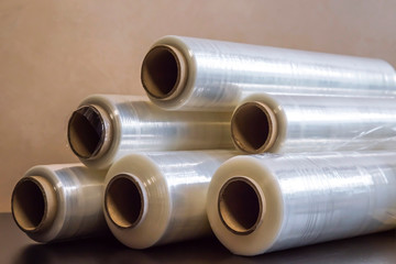 Packing material. Many rolls of stretch film are white transparent. Polymer product for wrapping.