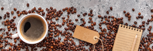 close-up-coffee-beans-coffee-cup-and-lined-paper-notebook-on-stone-table-top-view-panoramic-flat-lay