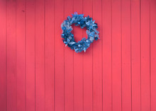 Christmas Colorful Decorative Wreaths On A Red Wooden Wall