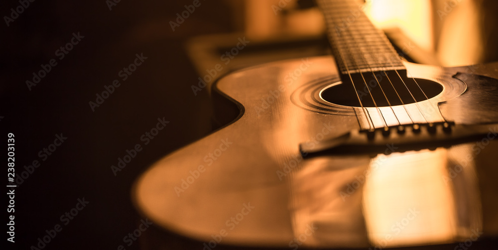 acoustic guitar close-up on a beautiful colored background - obrazy, fototapety, plakaty 
