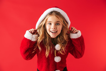 Wall Mural - Cute cheerful little girl wearing Christmas costume