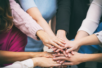 Group of women in the office at the seminar together discuss topics of interest hands close up