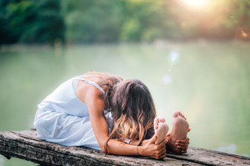 Wall Mural - Yoga Woman by The Lake. Seated Forward Bend