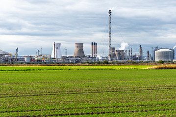 Oil Refinery at the edge of a cultivated field on a Cloudy Fall Day