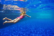 © Tropical studio - Happy family in swimming pool. Smiling child in goggles swim, dive in pool with fun - jump deep down underwater. Healthy lifestyle, people water sport activity, swimming lessons on holidays with kids