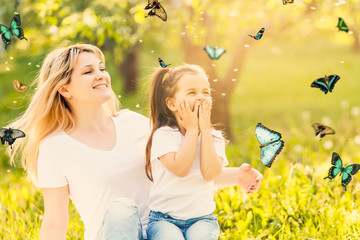 Wall Mural - Mother with little daughter in the park butterflies