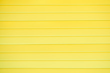 The Texture Of A Plastic Wall With Horizontal Stripes Of Yellow Boards, Background