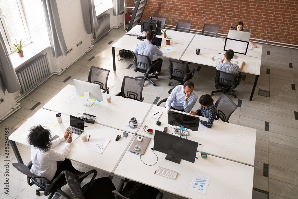 Employees working together in modern open office space, corporate group ...