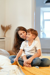 Wall Mural - Young woman and her cute son sped best moments together