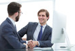 © ASDF - close up. handshake business partners sitting at the Desk