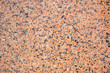 © Ana Fidalgo - Orange granite stone background. Black, gray and orange colored granite texture.