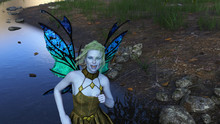 3d Illustration Of A Beautiful Green Haired Winged Fairy With Pale Blue Skin Wearing A Dress Dancing In A Forest Next To A Stream.