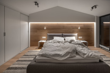 Wall Mural - Stylish bedroom in modern style with light walls and luminous lamps