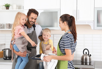 Canvas Print - Young woman treating her family with homemade oven baked pastry in kitchen