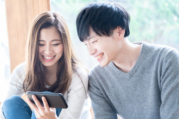 Canvas Print - young asian couple relaxing in living room