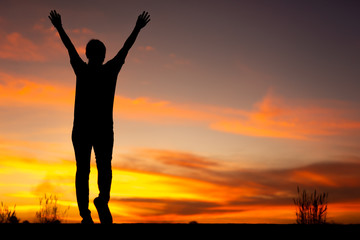 Wall Mural - Young woman relaxing in winter sunset sky outdoor.