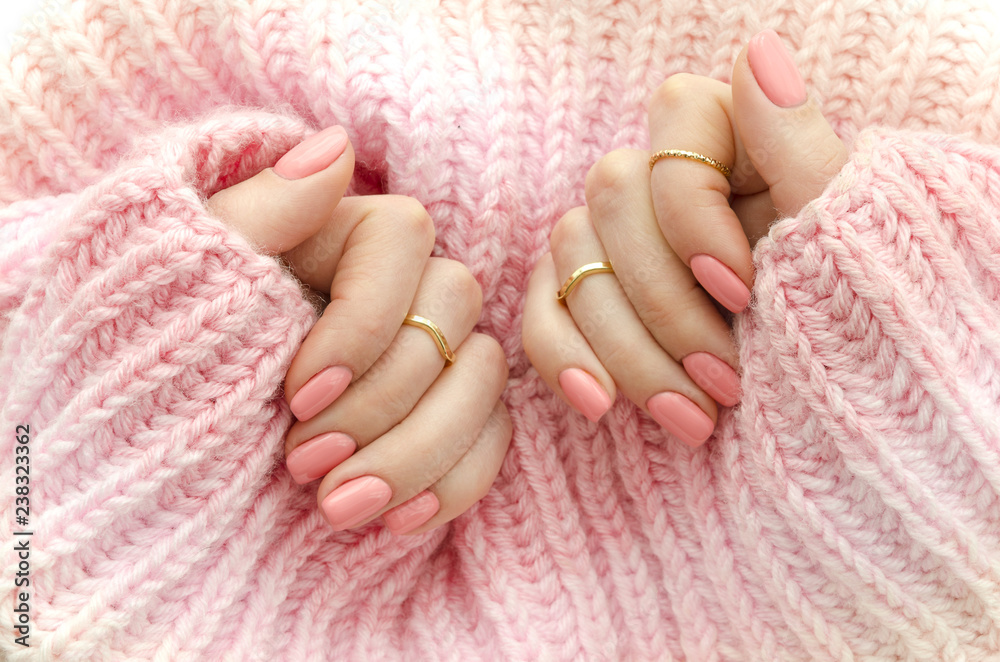 Nail Polish. Art Manicure. Modern style pink Nail Polish.Stylish pastel Color pink Nails holding wool material sleeve blouse . Classic wedding bride nails design - obrazy, fototapety, plakaty 