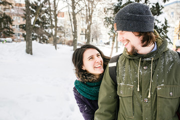 Happy Young Couple in Winter Park having fun