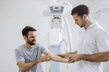 Wall Mural - Doctor Examining Patient's Hand