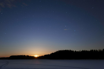 Wall Mural - moon rising over winter landscape at night