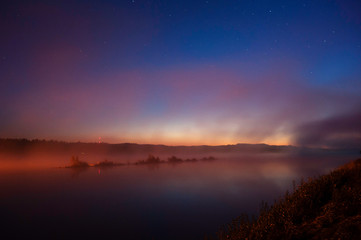 Wall Mural - mist over river in autumn. darkening sky with stars after sunset.