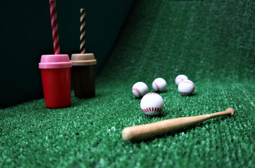 Baseball and bat on the  green grass with copy space