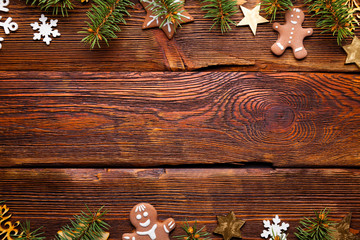 Poster - Christmas spruce tree, gingerbread cookies and decorations on wooden table