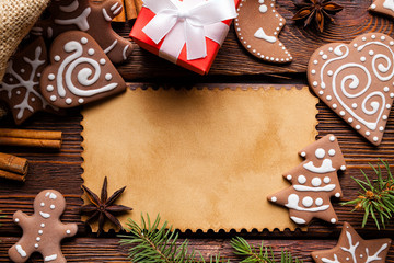 Sticker - Christmas background - blank paper card, gingerbread cookies, spices and gift box on wooden table