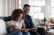 © ReeldealHD images - Smiling father and daughter using digital tablet at home