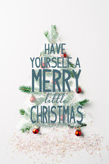 Wall Mural - top view of green pine branch decorated as festive christmas tree with glitters on white background 