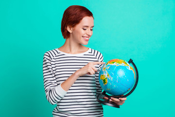 Next time I'll go to India! Photo portrait of funny funky joyful pretty excited cheerful glad friendly charity volunteer holding globe isolated turquoise background