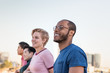 © ReeldealHD images - Group of friends looking out at city skyline view on a rooftop