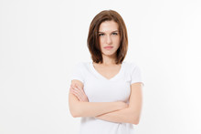 Upset And Angry Girl In White Blank T Shirt Isolated On White Background. Sad And Mad Woman With Crossed Arms . Copy Space.