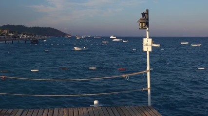 Wall Mural - Pier boat swaying on the white waves