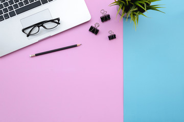 Fototapete - Flat lay of top view modern desk blue&pink pastel color tone work table with computer laptop and stationary in home office includes copyspace for add text or graphic