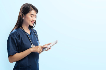 Young asian doctor woman with stethoscope using digital tablet