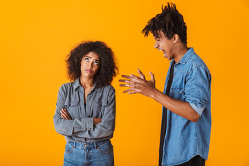 Poster - Young african couple standing isolated over yellow