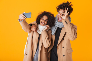 Sticker - Happy african couple wearing winter clothes