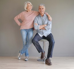 Wall Mural -  Full length of happy senior couple on grey background