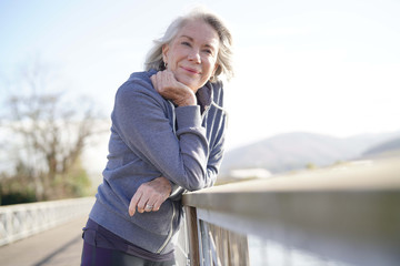  Portrait of attractive senior woman in sportswear outdoors