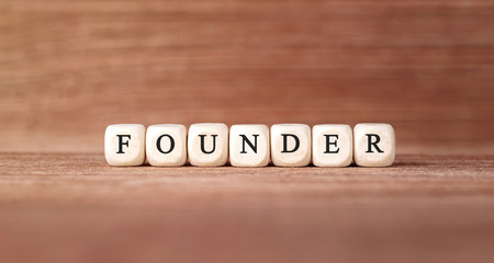 Poster - Word FOUNDER made with wood building blocks
