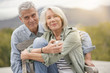 © goodluz - Loving portrait of modern senior couple outdoors