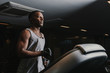 © ADDICTIVE STOCK - Black man running on treadmill in gym