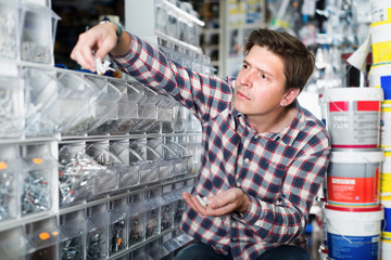 Wall Mural - Portrait of male in hardware store buying goods