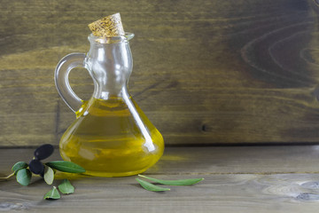 Apulian olive oil and olive branch on the wooden table, Italian food, mediterranean diet