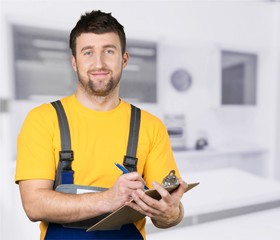 Wall Mural - Portrait of cheerful Handsome  mechanic  on background