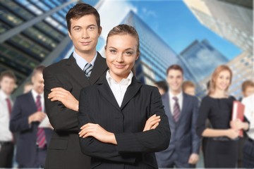 Canvas Print - Confident young Business couple with crossed hands on background