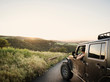 © Erik Isakson/Tetra Images - Woman in off road vehicle looking at sunset